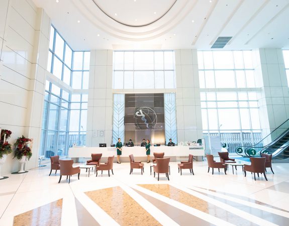 The bright, double-height reception lobby at World Medical Center Hospital
